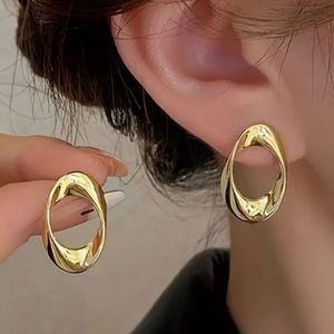 Sleek Oval Gold Toned Stud Earrings
